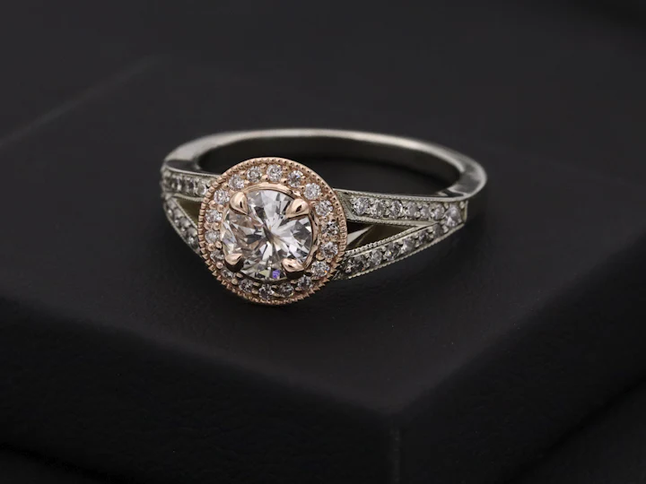 Diamond halo ring on a black stand